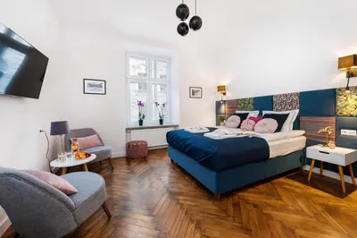 a bedroom with a bed and a couch and a chair at Luxury SPA Apartment Old Town Krakow in Kraków