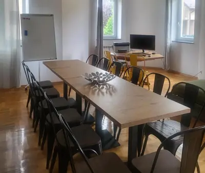 a classroom with a table and chairs and a whiteboard at THE CASTLE - Free Parking - Self Check In in Kraków