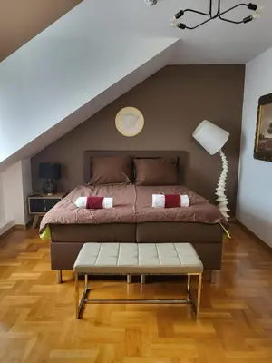 a bedroom with a large bed and a table at THE CASTLE - Free Parking - Self Check In in Kraków