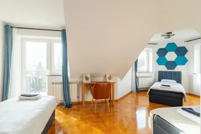a bedroom with two beds and a staircase at THE CASTLE - Free Parking - Self Check In in Kraków
