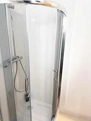 a shower with a glass door in a bathroom at THE CASTLE - Free Parking - Self Check In in Kraków