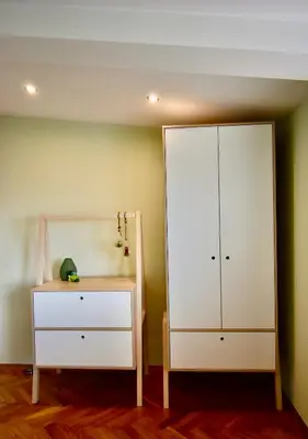 a bedroom with a white cabinet and a dresser at Kraków Krib in Kraków