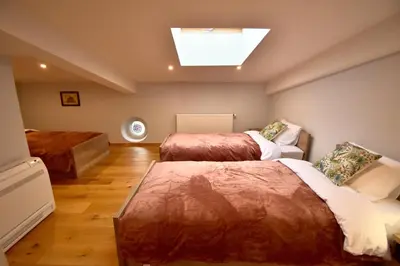 a bedroom with two beds and a skylight at Kraków Krib in Kraków