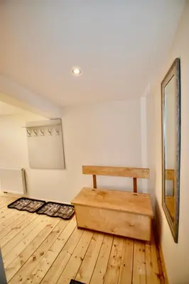 a room with a table and a wooden floor at Kraków Krib in Kraków