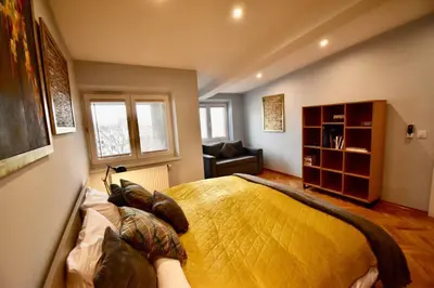 a bedroom with a bed and a chair at Kraków Krib in Kraków