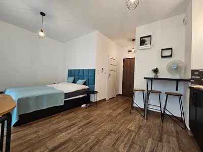 a bedroom with a bed and a table in it at Steam Park Rakowicka Koper Apartment in Kraków