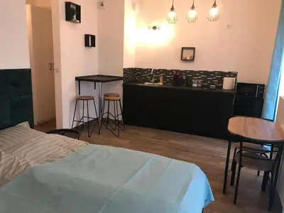 a bedroom with a bed and a table and chairs at Steam Park Rakowicka Koper Apartment in Kraków