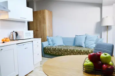 a kitchen with a table and a couch with fruit on it at 21 Floriańska Street Apartments in Kraków
