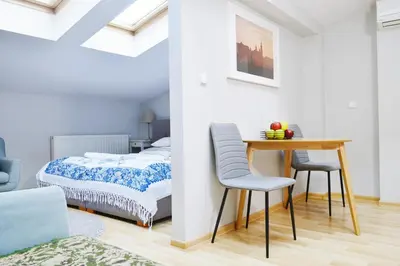 a bedroom with a bed and a table and chairs at 21 Floriańska Street Apartments in Kraków