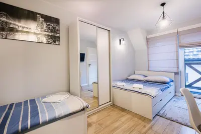 a bedroom with two beds and a mirror at Apartamenty,pokoje Paholski in Zubrzyca Górna