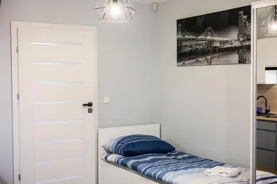 a small room with a door and a bed at Apartamenty,pokoje Paholski in Zubrzyca Górna