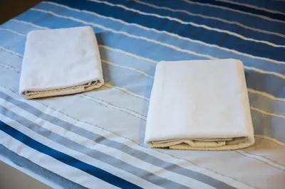 two towels sitting on top of a bed at Apartamenty,pokoje Paholski in Zubrzyca Górna