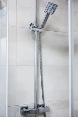 a shower with a shower head in a bathroom at Apartamenty,pokoje Paholski in Zubrzyca Górna