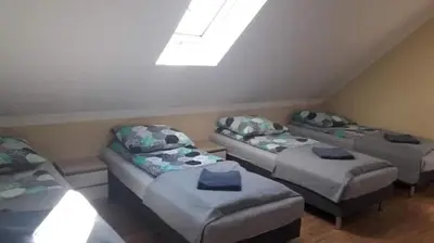 a room with four beds and a skylight at Mała Chatka domek Zator Oświęcim in Polanka Wielka