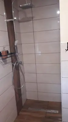a shower with a glass door in a bathroom at Mała Chatka domek Zator Oświęcim in Polanka Wielka