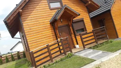 a wooden house with a door and a fence at Mała Chatka domek Zator Oświęcim in Polanka Wielka