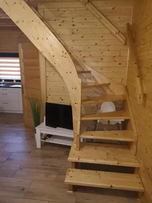 a staircase in a log cabin with a tv at Domki Całoroczne Danielowa Ostoja-Zator,Palczowice in Zator
