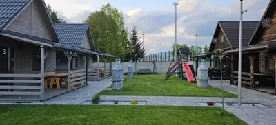 a yard with a playground at Domki Całoroczne Danielowa Ostoja-Zator,Palczowice in Zator