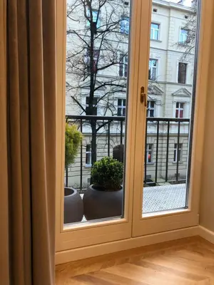 a window with a view of a building at POETICA APARTMENT in Kraków