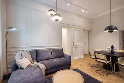 a living room with a couch and a table at POETICA APARTMENT in Kraków