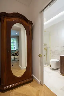 a bathroom with a large mirror in a room at POETICA APARTMENT in Kraków