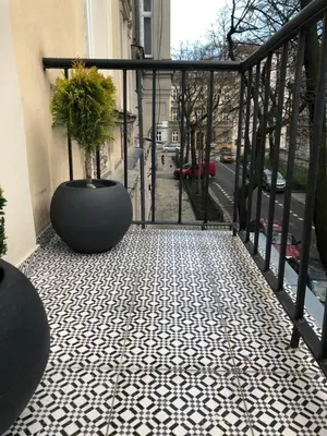 a balcony with a potted plant on a floor at POETICA APARTMENT in Kraków