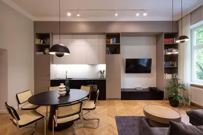 a living room with a table and chairs and a tv at POETICA APARTMENT in Kraków
