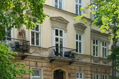 a building with windows and balconies on it at POETICA APARTMENT in Kraków