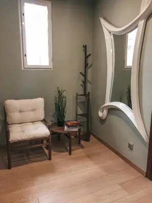 a living room with a chair and a table at Jaszczurowa Apartament II in Jaszczurowa