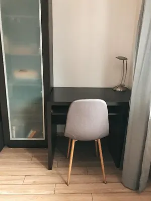 a desk with a chair in front of a mirror at Jaszczurowa Apartament II in Jaszczurowa