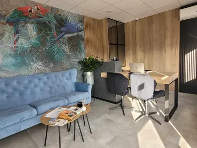 a living room with a couch and a desk with a laptop at Calm Village in Zator