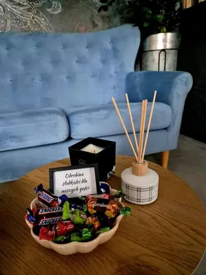 a table with a bowl of snacks and a box of sticks at Calm Village in Zator