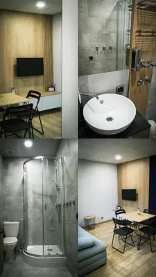 a bathroom with a sink and a shower and a table at Calm Village in Zator