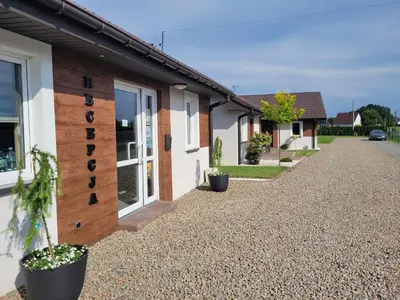 a row of houses with potted plants on a gravel road at Calm Village in Zator