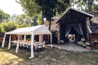 a tent with tables and chairs in front of a building at Kawalerski, Impreza, Wesele in Miechowice Wielkie