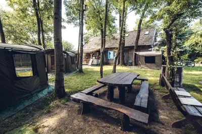 a picnic table in front of a group of tents at Kawalerski, Impreza, Wesele in Miechowice Wielkie