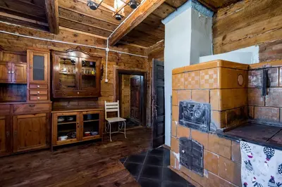 a living room with a fireplace and wooden walls at Kawalerski, Impreza, Wesele in Miechowice Wielkie