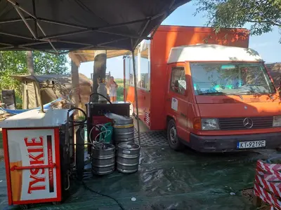 a red food truck parked next to a tent at Kawalerski, Impreza, Wesele in Miechowice Wielkie