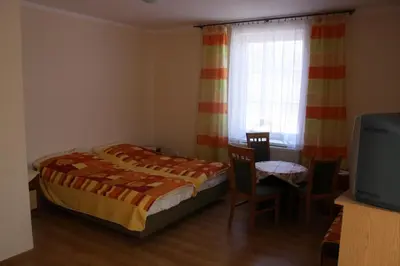 a small bedroom with two beds and a window at Diablak in Zawoja