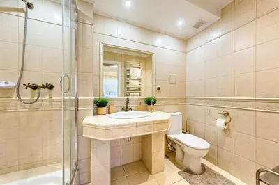 a bathroom with a toilet and a sink and a shower at Apartament Kapelanka CoWork in Kraków