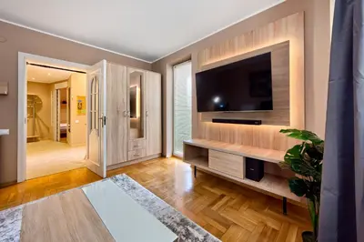 a living room with a flat screen tv on a wall at Apartament Kapelanka CoWork in Kraków