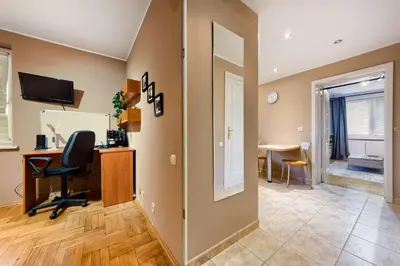 an office with a desk and a chair in a room at Apartament Kapelanka CoWork in Kraków