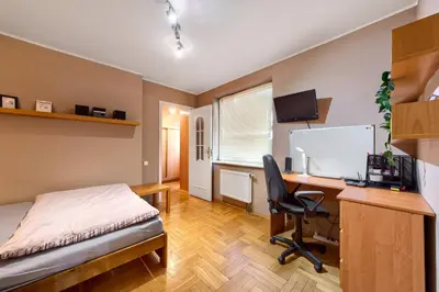 a bedroom with a desk and a bed and a computer at Apartament Kapelanka CoWork in Kraków