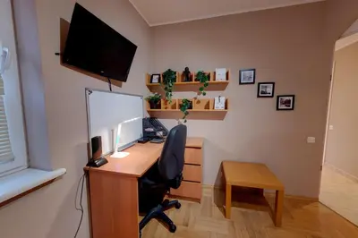 an office with a desk with a computer and a monitor at Apartament Kapelanka CoWork in Kraków