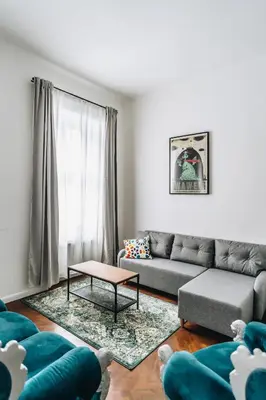 a living room with a couch and a table at Podzamcze 24 Apartments in Kraków