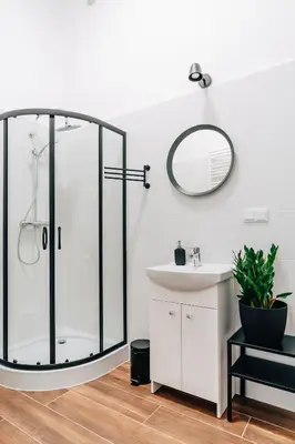a bathroom with a glass shower and a sink at Podzamcze 24 Apartments in Kraków