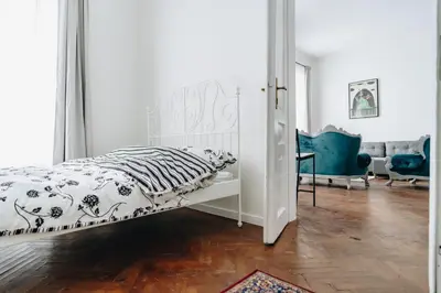 a bedroom with a white bed with a zebra blanket at Podzamcze 24 Apartments in Kraków