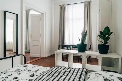 a bedroom with a bed and a table and potted plants at Podzamcze 24 Apartments in Kraków