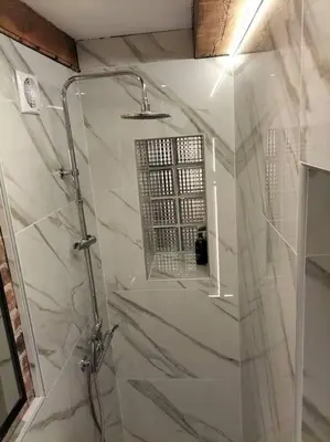 a bathroom with a shower with a glass door at Uroczy apartament w centrum Krakowa in Kraków