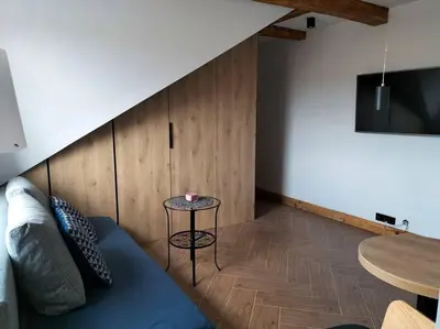 a living room with a couch and a table at Uroczy apartament w centrum Krakowa in Kraków